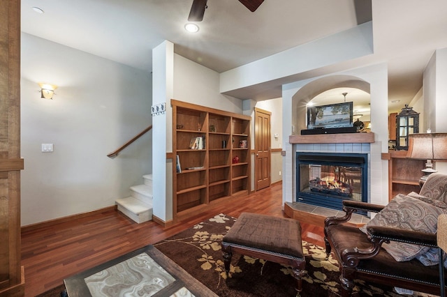316 S 10th Pl, Coeur D Alene, ID 83814 - living area featuring a tile fireplace, ceiling fan, wood finished floors, stairway, and baseboards