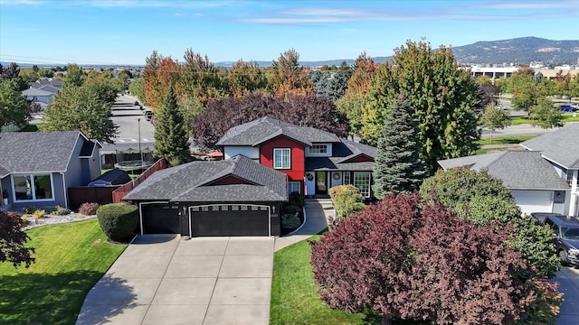 23513 E Maxwell Ct, Liberty Lake, WA 99019 - view of front facade with an attached garage, concrete driveway, a residential view, a front yard, and a shingled roof