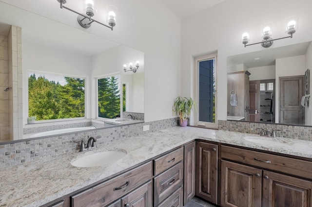 11818 N Mountain Trail Ln, Spokane, WA 99217 - bathroom featuring double vanity, tasteful backsplash, and a chandelier