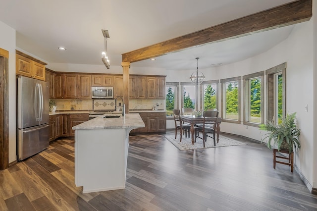 11818 N Mountain Trail Ln, Spokane, WA 99217 - kitchen featuring appliances with stainless steel finishes, healthy amount of natural light, backsplash, light stone countertops, and recessed lighting