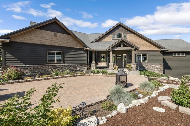 11818 N Mountain Trail Ln, Spokane, WA 99217 - craftsman-style home featuring stone siding and covered porch