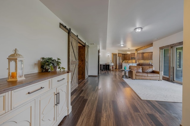 11818 N Mountain Trail Ln, Spokane, WA 99217 - living room featuring a barn door and dark wood finished floors