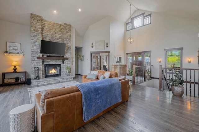 11818 N Mountain Trail Ln, Spokane, WA 99217 - living area featuring wood finished floors, high vaulted ceiling, and a fireplace