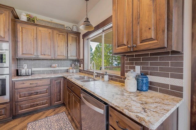 11818 N Mountain Trail Ln, Spokane, WA 99217 - kitchen featuring stainless steel dishwasher, a sink, wood finished floors, and decorative backsplash