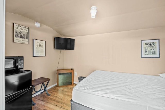 91 Moonlight Ln, Newport, WA 99156 - bedroom with vaulted ceiling, wood finished floors, and baseboards