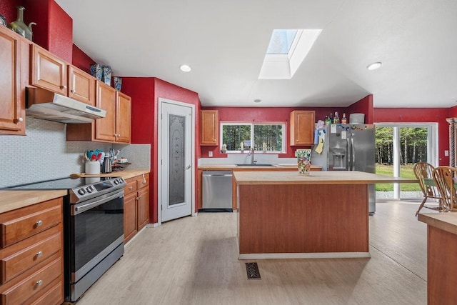 91 Moonlight Ln, Newport, WA 99156 - kitchen with appliances with stainless steel finishes, under cabinet range hood, a skylight, a sink, and light countertops