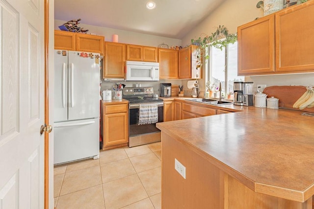 kitchen featuring white appliances, a sink, light tile patterned floors, a peninsula, and light countertops