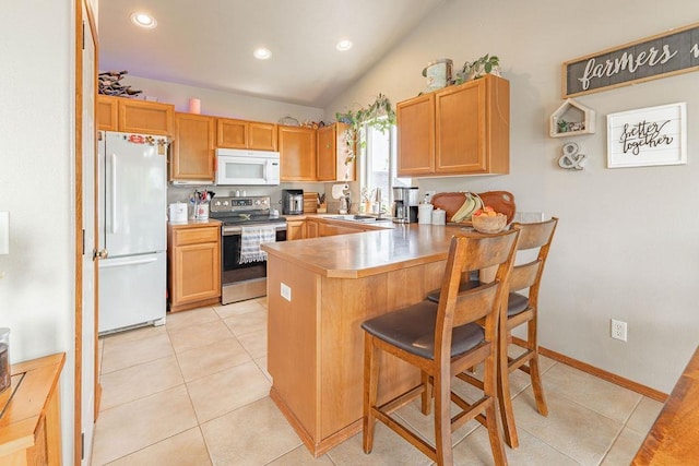 kitchen featuring white appliances, a sink, a peninsula, light tile patterned flooring, and vaulted ceiling