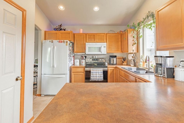 kitchen with white appliances, a sink, recessed lighting, and light countertops