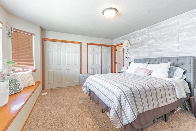 carpeted bedroom with two closets