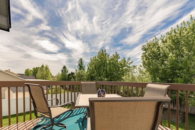 wooden terrace featuring fence and outdoor dining area
