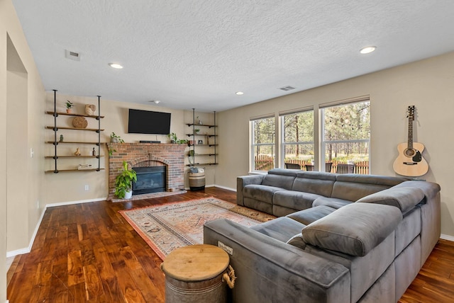 7007 N Tucannon Ct, Spokane, WA 99208 - living area featuring wood finished floors, a textured ceiling, a fireplace, and recessed lighting