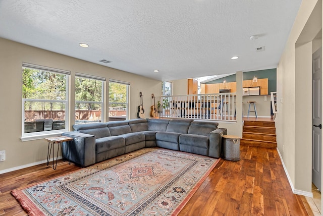 7007 N Tucannon Ct, Spokane, WA 99208 - living room with wood-type flooring, a textured ceiling, stairway, plenty of natural light, and recessed lighting