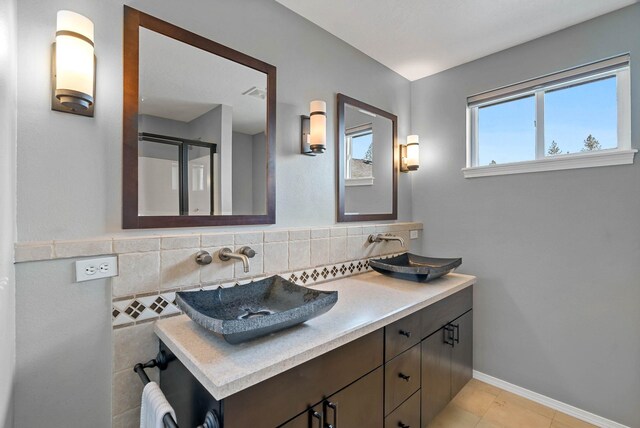 7007 N Tucannon Ct, Spokane, WA 99208 - bathroom with double vanity, a stall shower, and tile patterned flooring