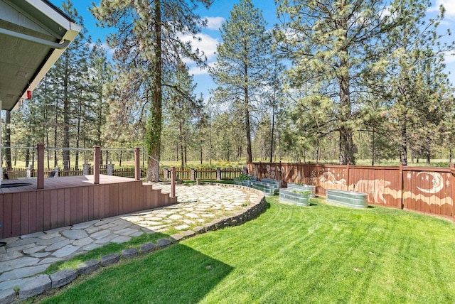 7007 N Tucannon Ct, Spokane, WA 99208 - fenced backyard with a deck, a patio, and view of scattered trees