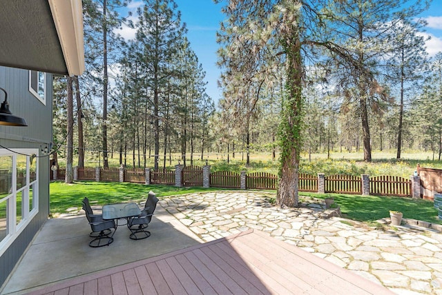7007 N Tucannon Ct, Spokane, WA 99208 - deck with a patio area, outdoor dining area, and view of scattered trees