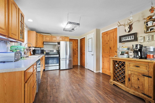 15205 N Scribner Branch Rd, Spokane, WA 99217 - kitchen featuring stainless steel appliances, light countertops, under cabinet range hood, and dark wood finished floors