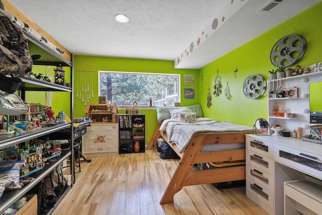 15205 N Scribner Branch Rd, Spokane, WA 99217 - bedroom with a textured ceiling and wood finished floors