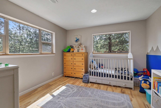 15205 N Scribner Branch Rd, Spokane, WA 99217 - bedroom featuring wood finished floors, recessed lighting, and baseboards