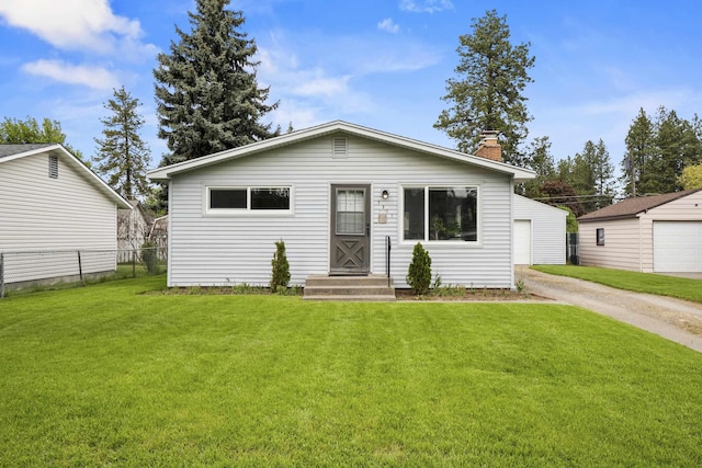 view of front of home with a chimney and a detached garage