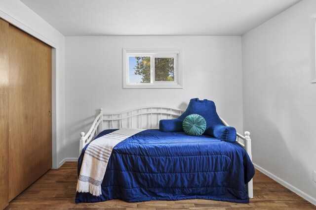 bedroom with wood finished floors and baseboards