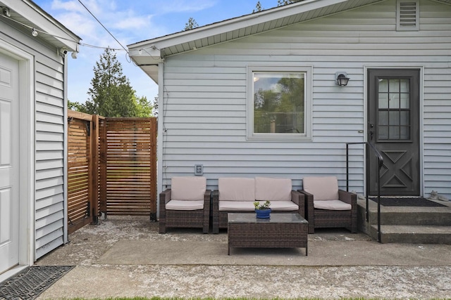 view of patio with an outdoor living space and fence