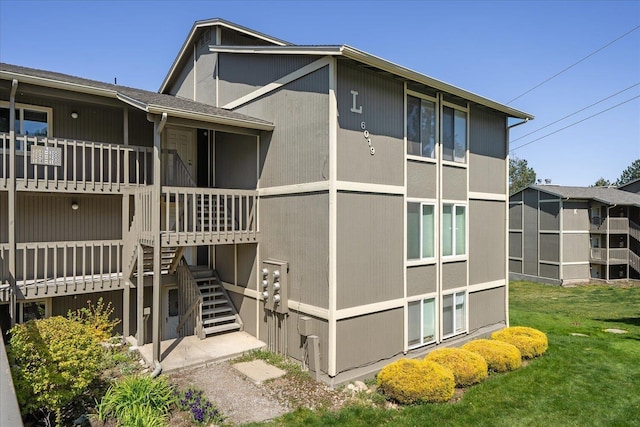 6019 E 6th Ave Unit L-201, Spokane, WA 99212 - view of home's exterior featuring stairway and a lawn