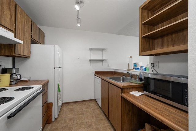 6019 E 6th Ave Unit L-201, Spokane, WA 99212 - kitchen with white appliances, open shelves, a sink, under cabinet range hood, and baseboards