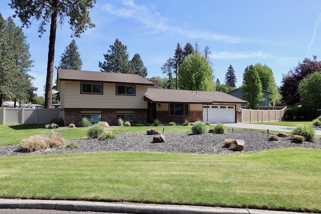 13703 E 31st Ave, Spokane Valley, WA 99216 - tri-level home with an attached garage, brick siding, and driveway