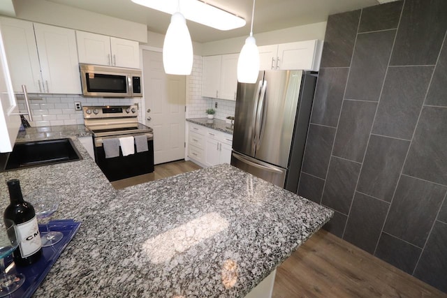 13703 E 31st Ave, Spokane Valley, WA 99216 - kitchen featuring appliances with stainless steel finishes, dark wood-style flooring, stone counters, and white cabinetry