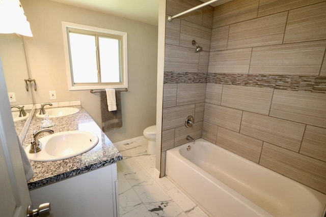 13703 E 31st Ave, Spokane Valley, WA 99216 - bathroom featuring marble look tiles, baseboards, toilet, double vanity, and washtub / shower combination