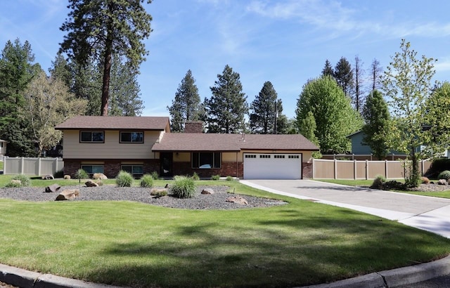 13703 E 31st Ave, Spokane Valley, WA 99216 - split level home featuring an attached garage, brick siding, and driveway