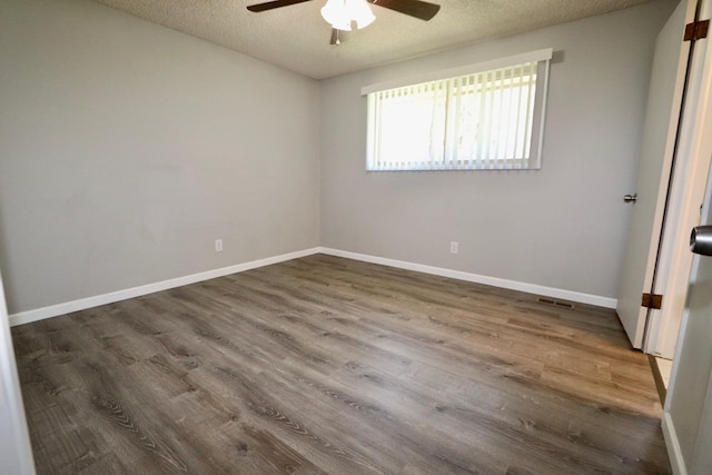 13703 E 31st Ave, Spokane Valley, WA 99216 - spare room with ceiling fan, dark wood-style flooring, a textured ceiling, and baseboards