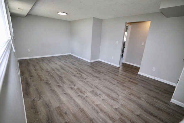 13703 E 31st Ave, Spokane Valley, WA 99216 - unfurnished room with wood finished floors, baseboards, and a textured ceiling