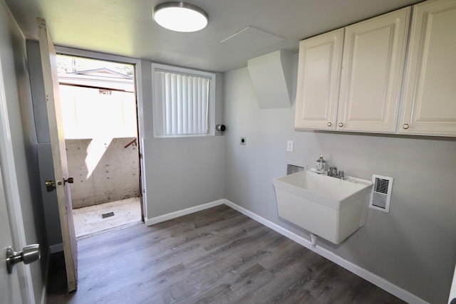 13703 E 31st Ave, Spokane Valley, WA 99216 - laundry area featuring hookup for an electric dryer, cabinet space, wood finished floors, and baseboards