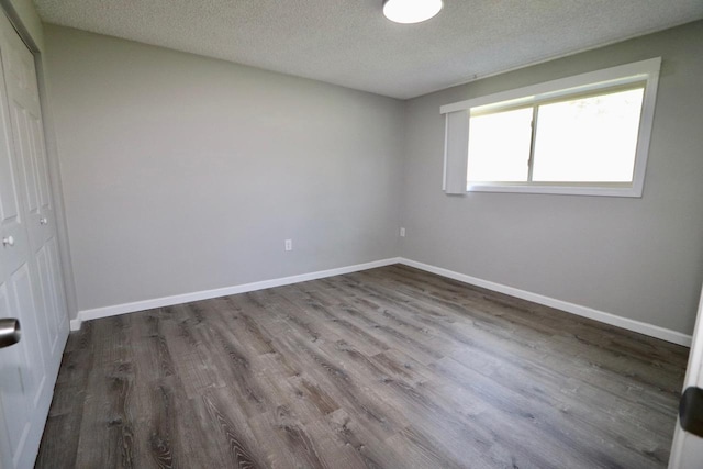 13703 E 31st Ave, Spokane Valley, WA 99216 - empty room with wood finished floors, a textured ceiling, and baseboards