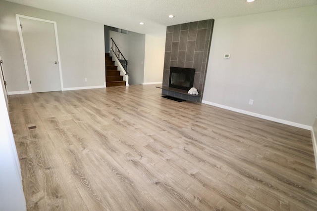 13703 E 31st Ave, Spokane Valley, WA 99216 - unfurnished living room featuring recessed lighting, stairway, a textured ceiling, wood finished floors, and baseboards
