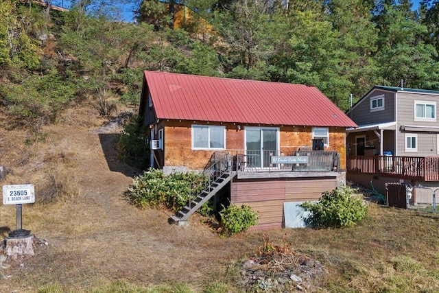 23605 E Beach Ln, Newman Lake, WA 99025 - view of front of property featuring stairway, metal roof, a deck, and brick siding