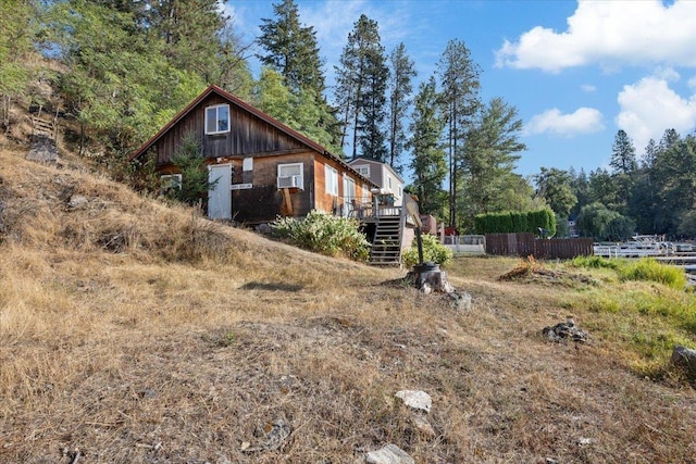 23605 E Beach Ln, Newman Lake, WA 99025 - view of side of home featuring fence, a deck, and stairway