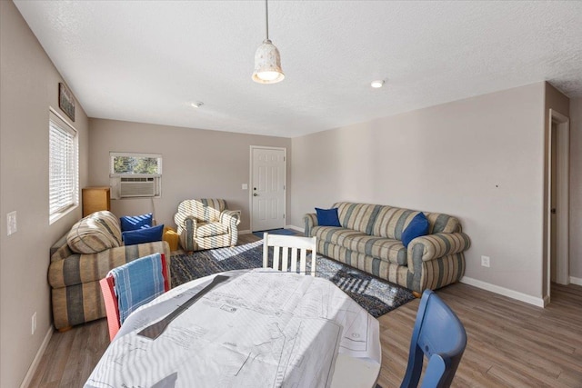 23605 E Beach Ln, Newman Lake, WA 99025 - bedroom with baseboards, wood finished floors, a textured ceiling, and cooling unit
