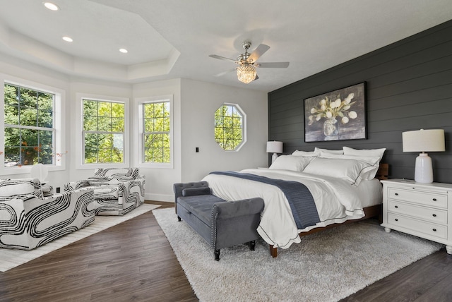 bedroom featuring wood finished floors, baseboards, recessed lighting, ceiling fan, and wooden walls