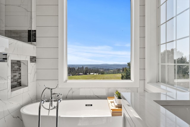 bathroom with a freestanding bath and a mountain view