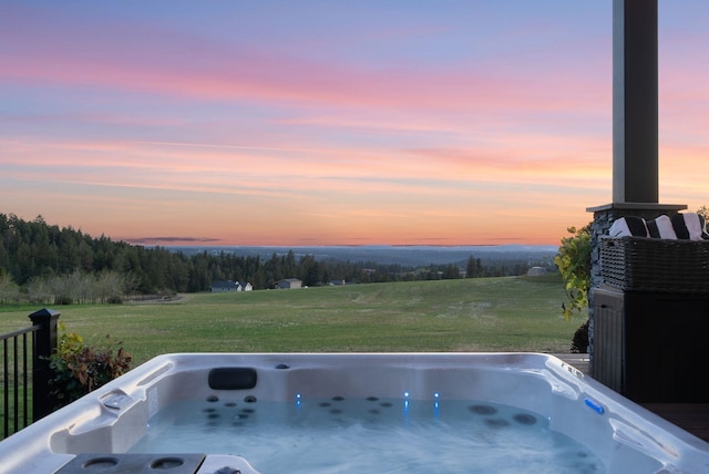 view of patio featuring a hot tub and a view of countryside