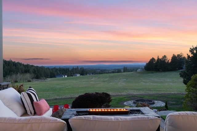 view of patio featuring an outdoor living space with a fire pit and a view of rural / pastoral area