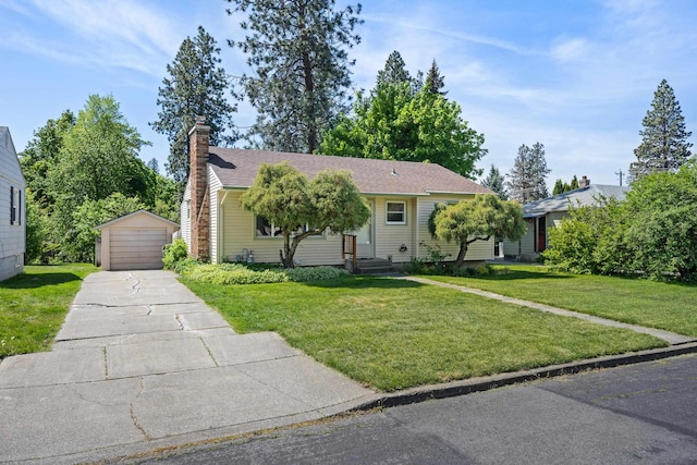 ranch-style home with an outbuilding, a garage, a chimney, and a front lawn