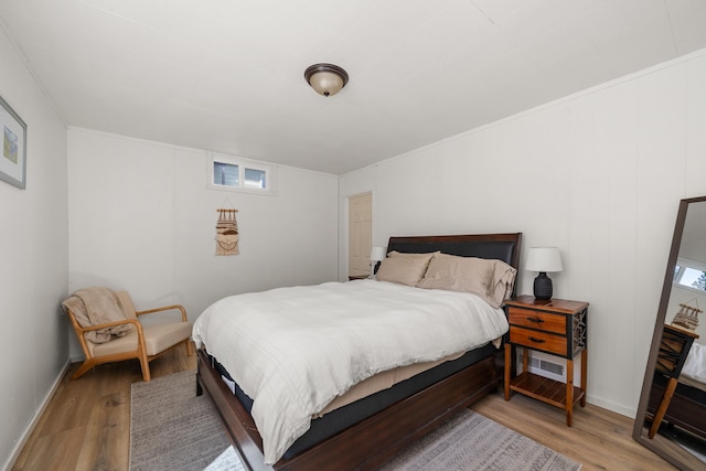 bedroom with wood finished floors and baseboards