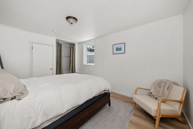 bedroom featuring wood finished floors and baseboards