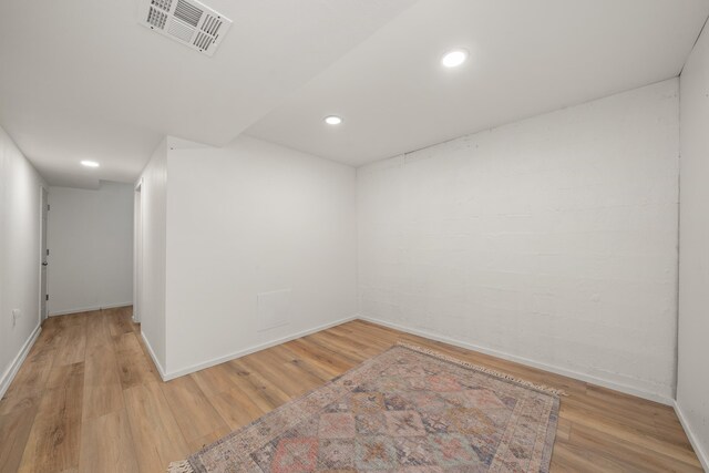 spare room featuring wood finished floors, baseboards, and recessed lighting