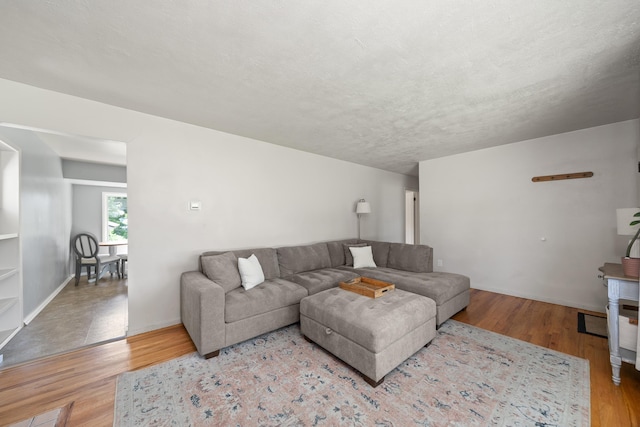 living area featuring wood finished floors and baseboards