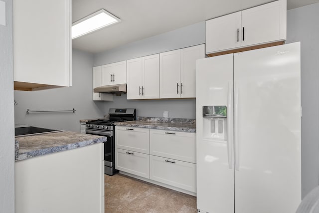 kitchen with white refrigerator with ice dispenser, stainless steel gas range oven, under cabinet range hood, white cabinetry, and a sink